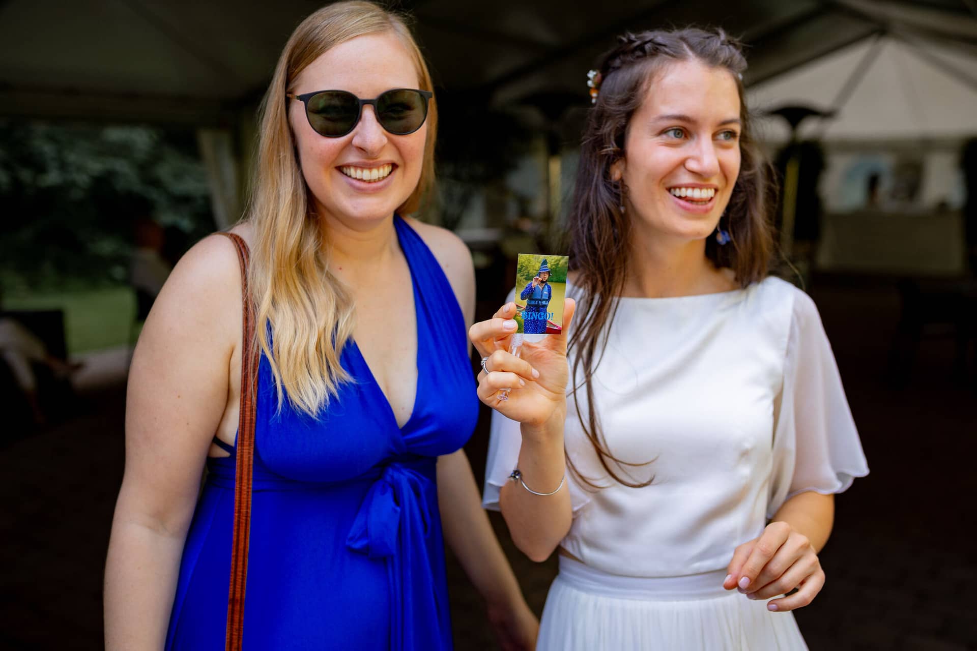 20230811 16 30 53 Hochzeit Elztal Hochzeitsfotograf Heiraten Heidelberg Landgasthof Heidersbacher Muehle 4K8A5297.BdGoLobG Zwei Frauen lachen herzlich beim Empfang – entspannte und fröhliche Stimmung unter den Gästen